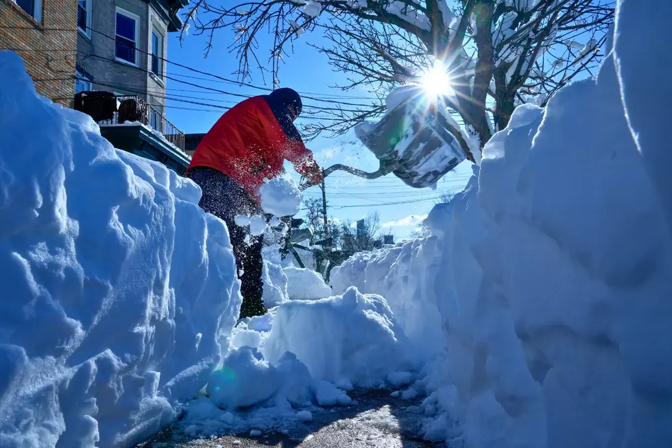 Luis Javier Rodriguez clears snow from a sidewalk Feb. 24, 2026, in Weekhawken, NJ (AP Photo/Seth Wenig)
