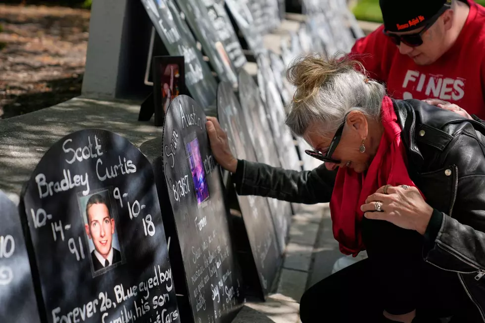 Tanny Austin cries while looking at tombstones with the names of victims of the opioid crisis, including her son Sean Austin, during a rally outside of a courthouse in Newark, N.J., Tuesday, April 21, 2026.