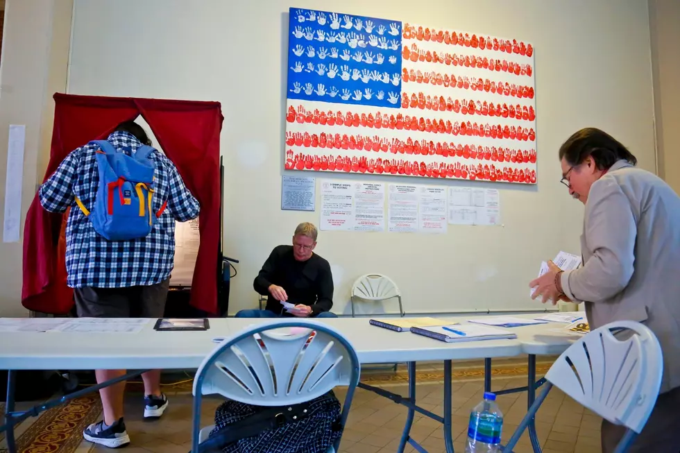 Poll station administrators work as a voter enters the booth at City Hall on June 6, 2017, in Hoboken, NJ (AP Photo/Bebeto Matthews)