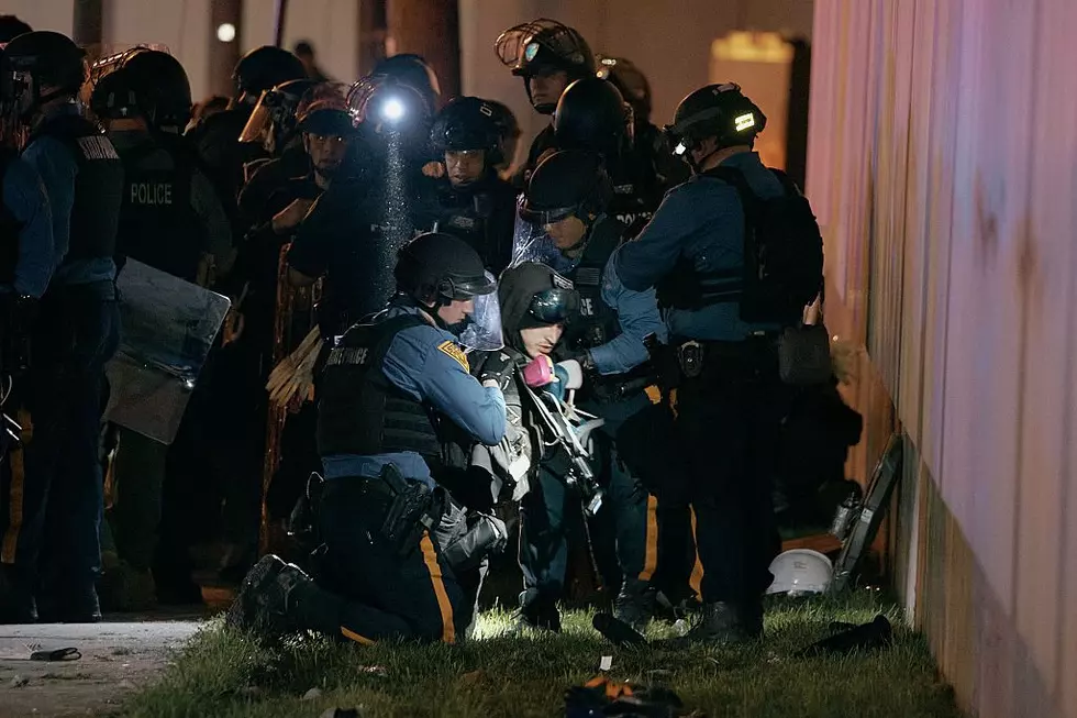 NEWARK, NEW JERSEY - MAY 31: Police arrest a protester near the Delaney Hall detention center on May 31, 2026 in Newark, New Jersey. Mayor Ras Baraka of Newark has ordered a mandatory curfew surrounding Delaney Hall from 9 PM Saturday until 6 AM Sunday. Tensions remain high outside the detention facility where activists have clashed with police for days after detainees began a hunger strike over Memorial Day weekend amid allegations of inhumane living conditions. (Photo by Andres Kudacki/Getty Images)
