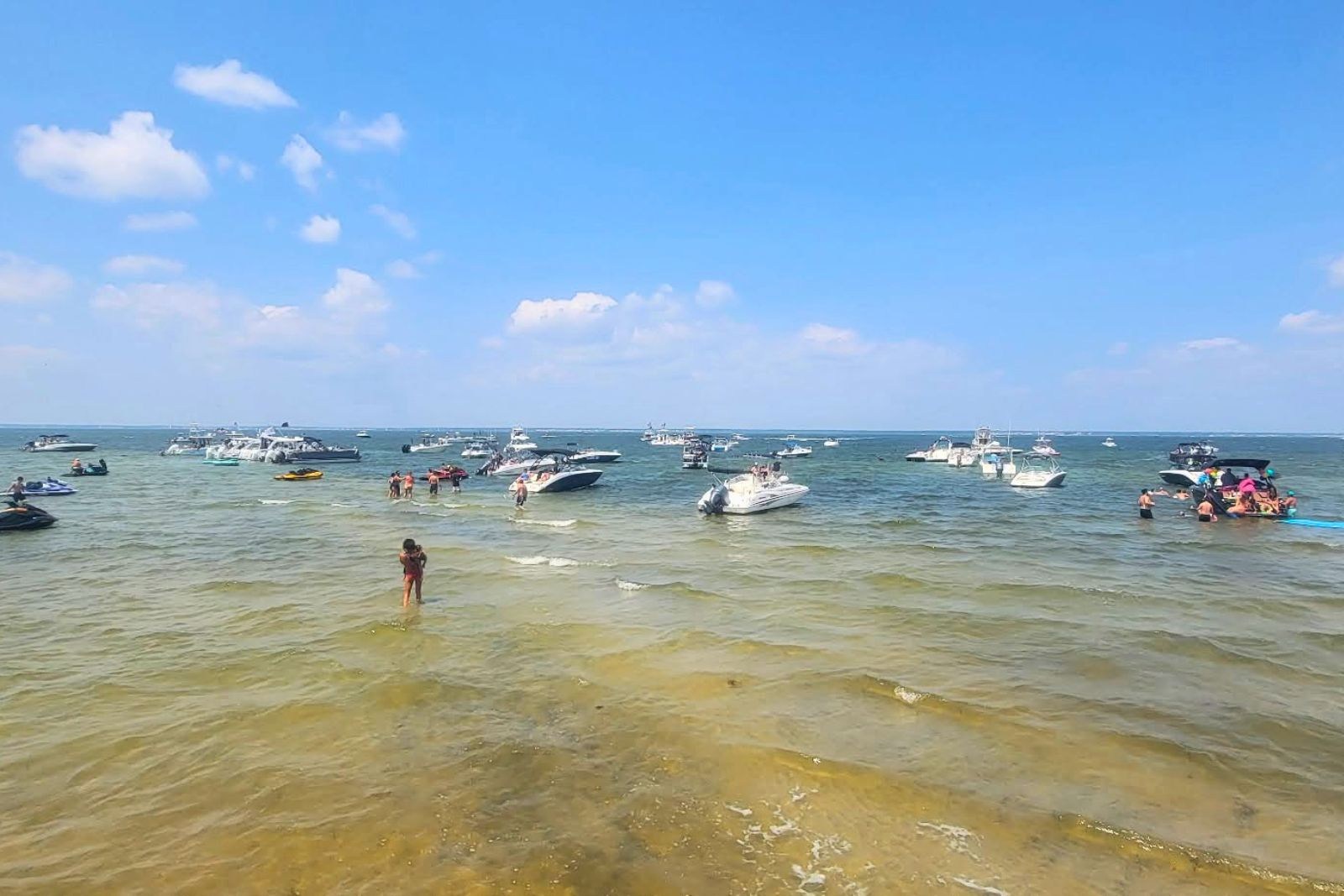 Jersey Shore beach with surfers and ocean waves on Friday