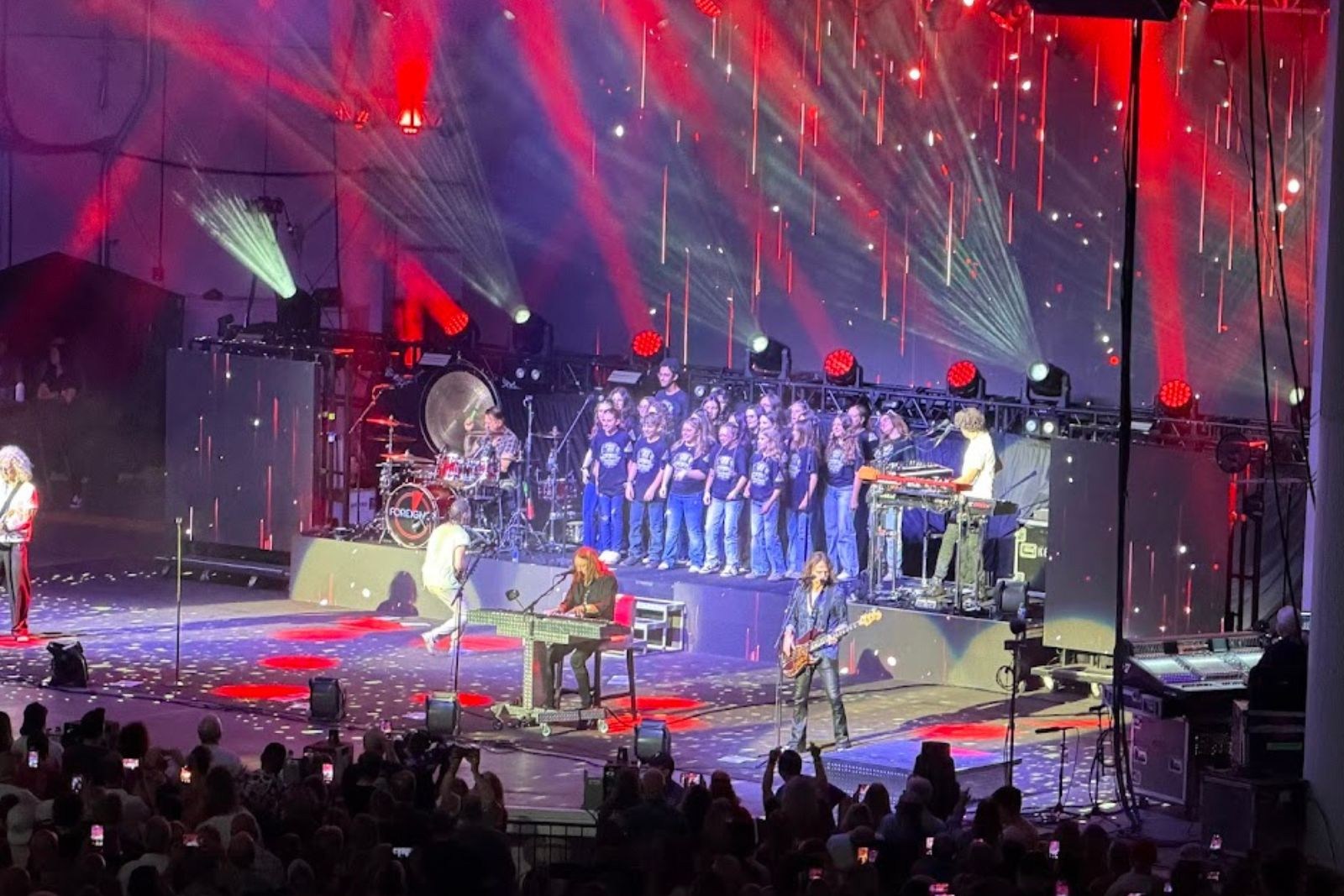 Manchester Township Middle School chorus performing on stage with rock band Foreigner at PNC Bank Arts Center
