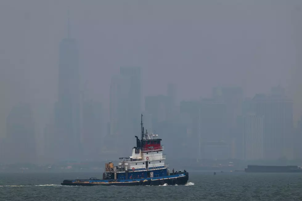 Haze from Canadian wildfires blankets the Manhattan skyline as seen from a Brooklyn pier on July 15, 2026 in New York City