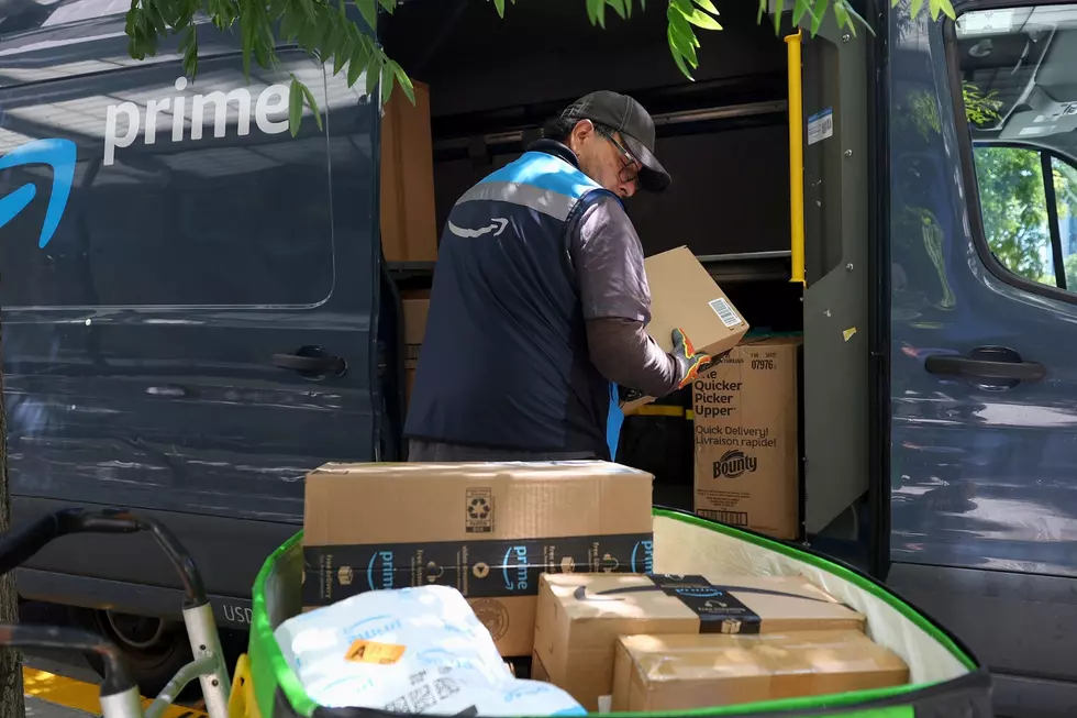 An Amazon delivery driver loads a cart with packages on July 16, 2024. (Photo by Justin Sullivan/Getty Images)