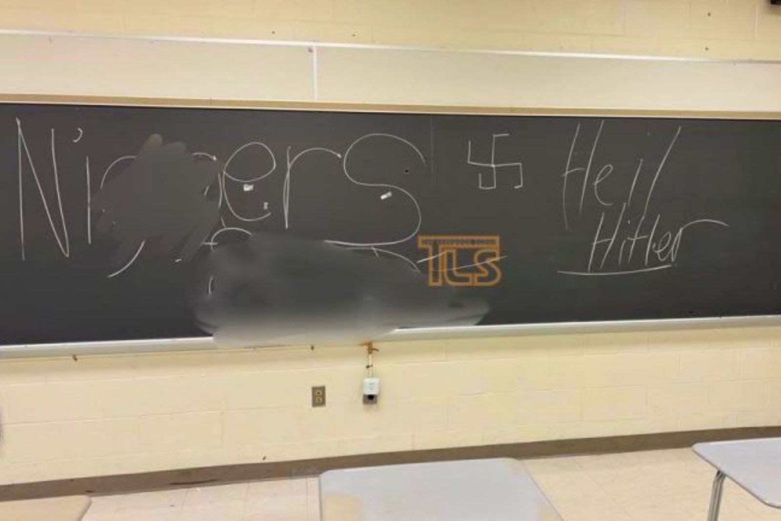 Interior of vacant Jackson school showing hateful graffiti vandalism