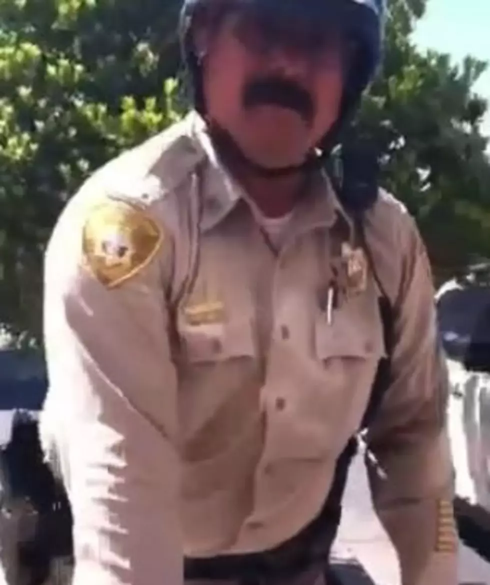 Watch a 12-Year-Old Confront a Cop for Parking His Motorcycle on the Sidewalk [VIDEO]