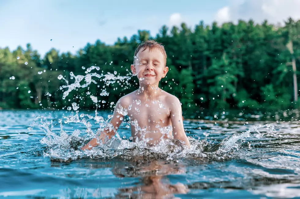 boy splashes in the lake