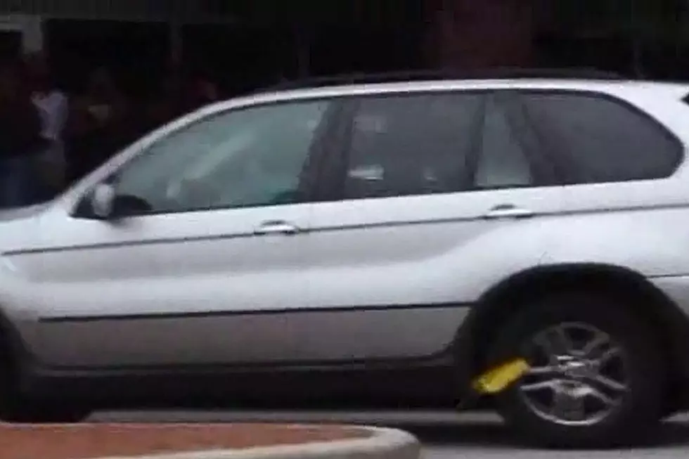 Woman Who Just Doesn’t Care Drives Booted BMW