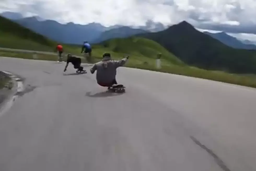 Speeding Downhill Skateboarders Zoom Right By Cyclists