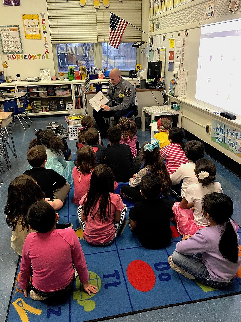 Toms River Police Officer reads to students on National Dr. Suess Day