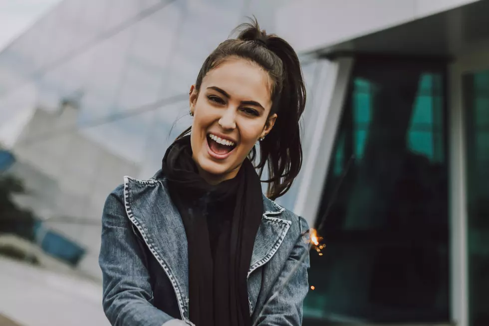 Woman smiling. (Photo by Vinicius Wiesehofer on Unsplash)