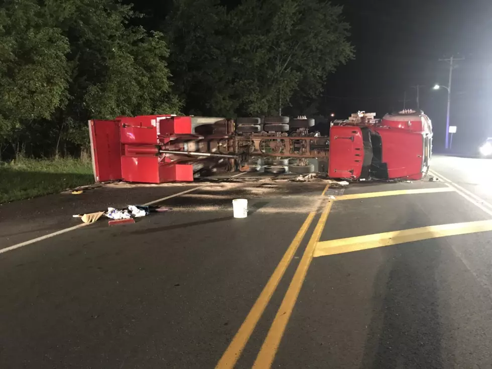 Dump truck overturns in Manchester and takes down telephone wires and snaps utility pole