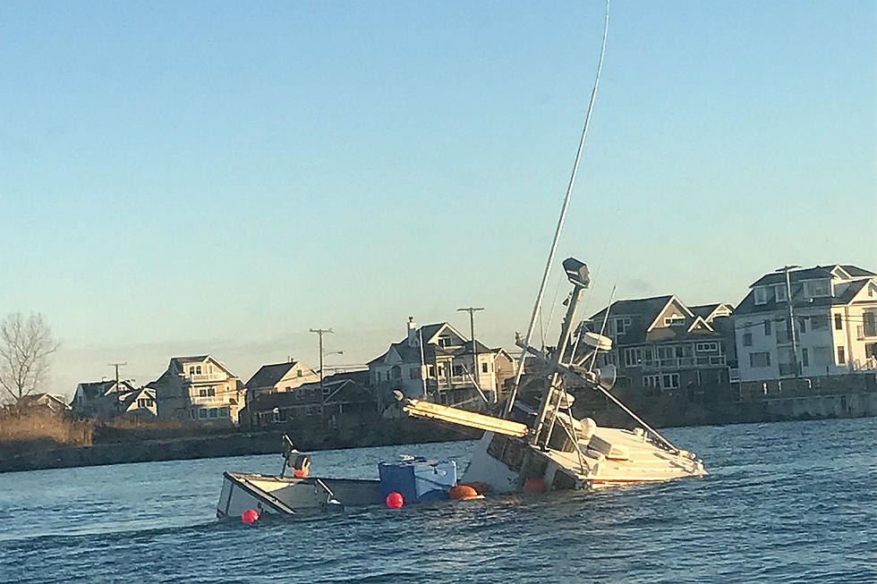 Coast Guard rescues three people and a dog from sinking boat