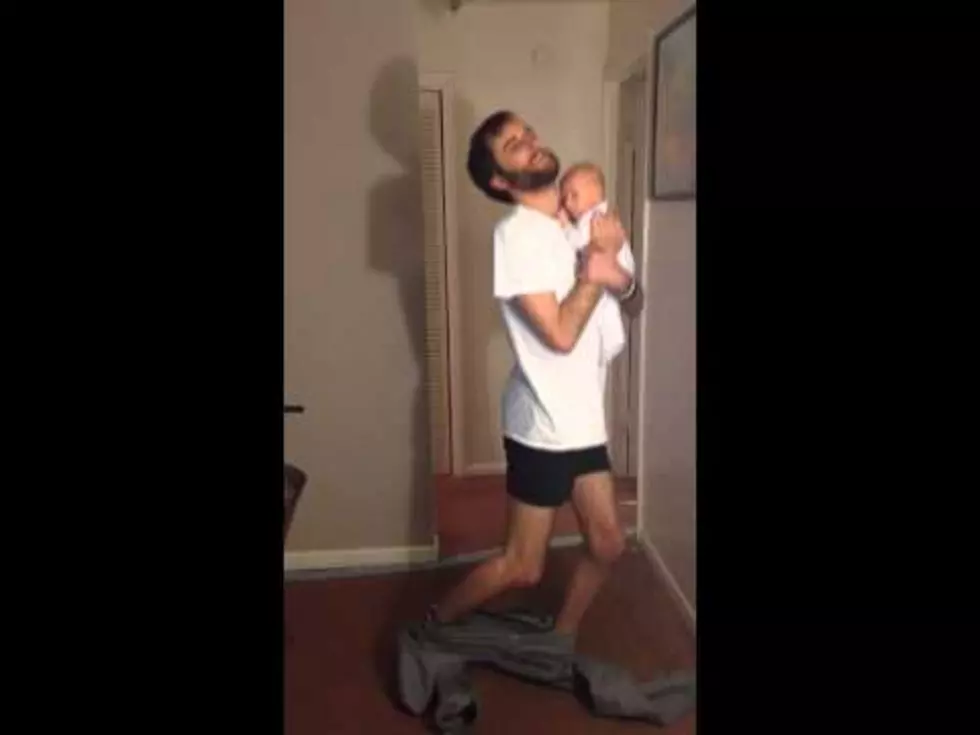 Daring Dad Puts Pants On Without Hands While Holding Baby [VIDEO]