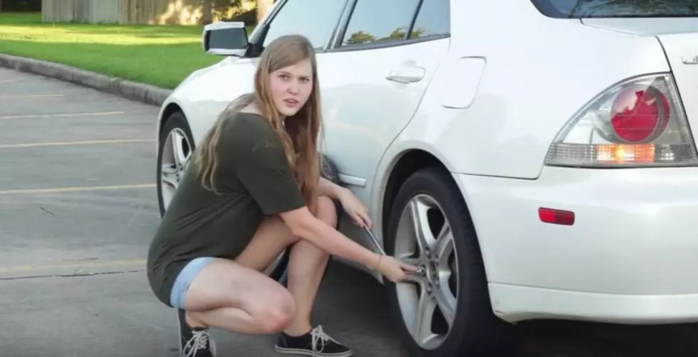 A Woman Changes a Tire