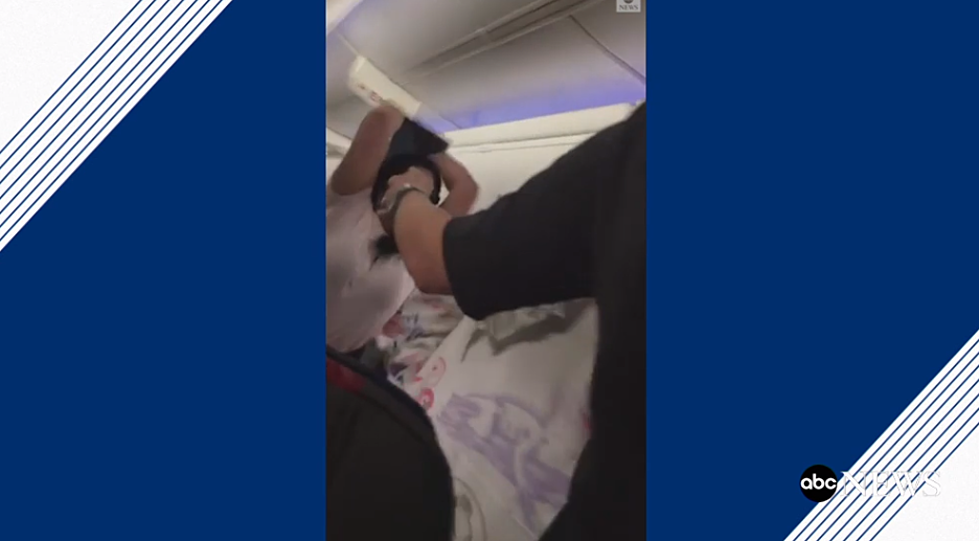 Wife Hits Husband with Laptop on American Airlines Flight [VIDEO]