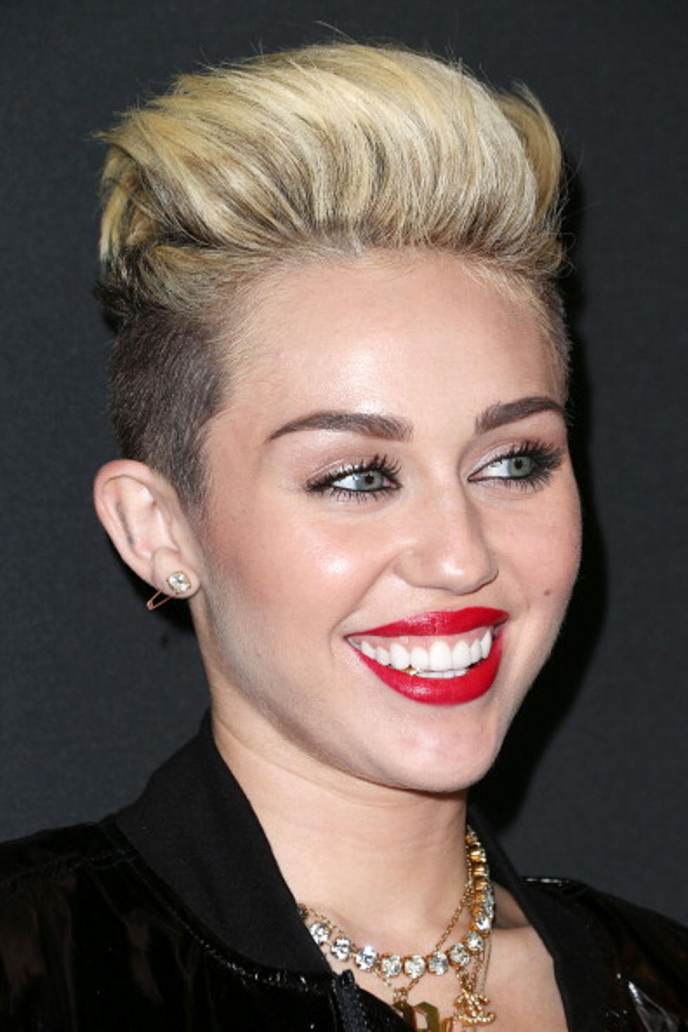 Miley Cyrus Shows off Gold Tooth Bling at MySpace Event