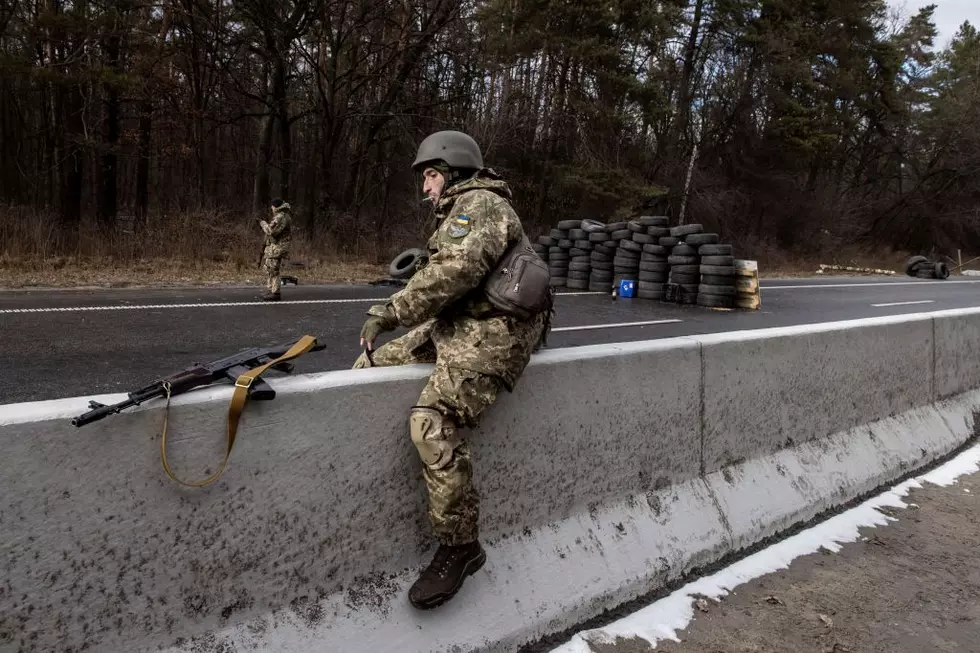KYIV, UKRAINE - MARCH 08: A member of the Ukrainian military jumps a road divider at a forward position on the eastern frontline near Kalynivka village as Russian forces advanced on March 08, 2022, in Kyiv, Ukraine. Russia continues assault on Ukraine's major cities, including the capital Kyiv, after launching a large-scale invasion of the country on February 24. (Photo by Chris McGrath/Getty Images)