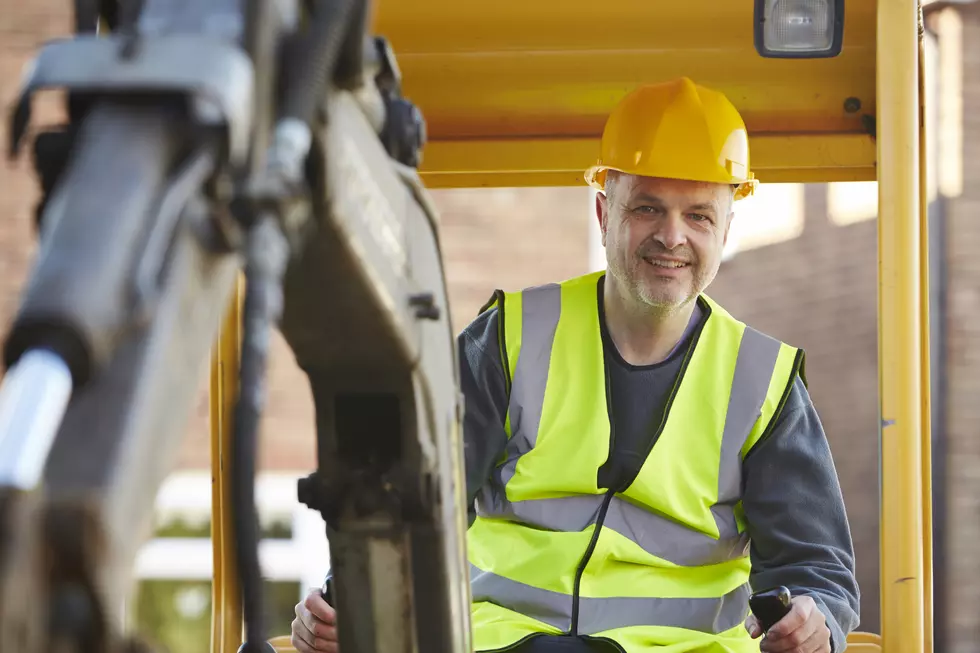 Construction Worker Operating Digger On Site