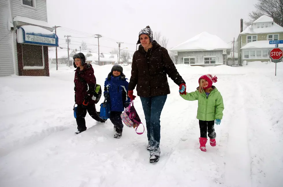 BUFFALO, NY - DECEMBER 2: (L-R) Jacob Raab, Alexander Raab, Alisa Raab and Ryan Raab navigate snow-covered streets after a five mile wide band of lake-effect snow dumped more than two feet of snow and closed a 16-mile stretch of the New York State Thruway December 2, 2010 in Buffalo, New York. Some drivers on the thruway remained trapped in their cars for more than 15 hours. (Photo by John Normile/Getty Images)