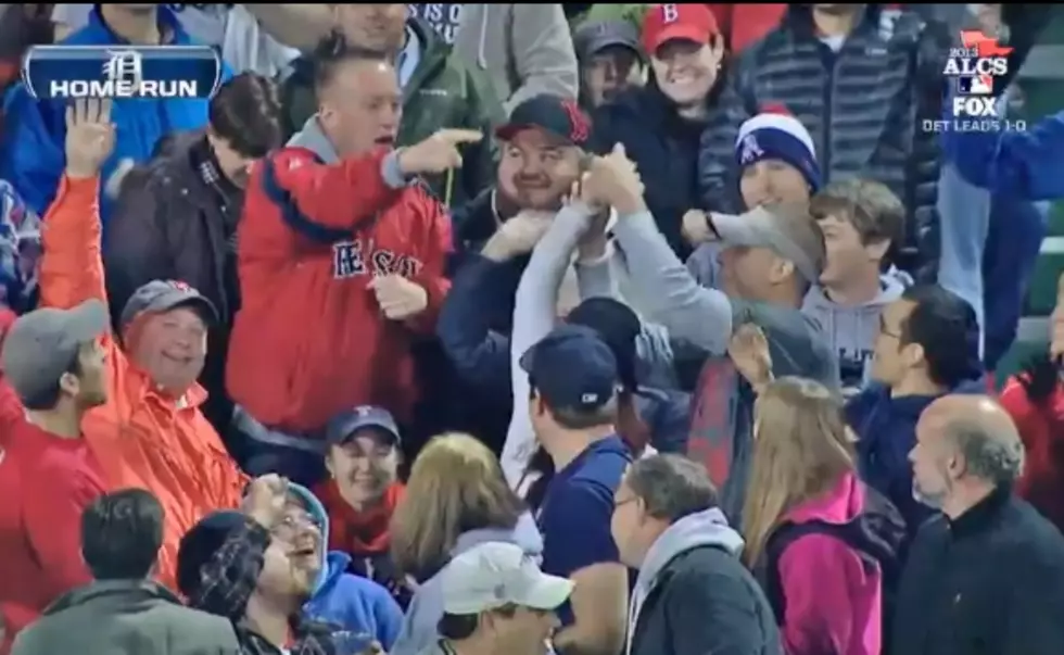 An Aggressive Red Sox fan rips a home run ball from female's hands