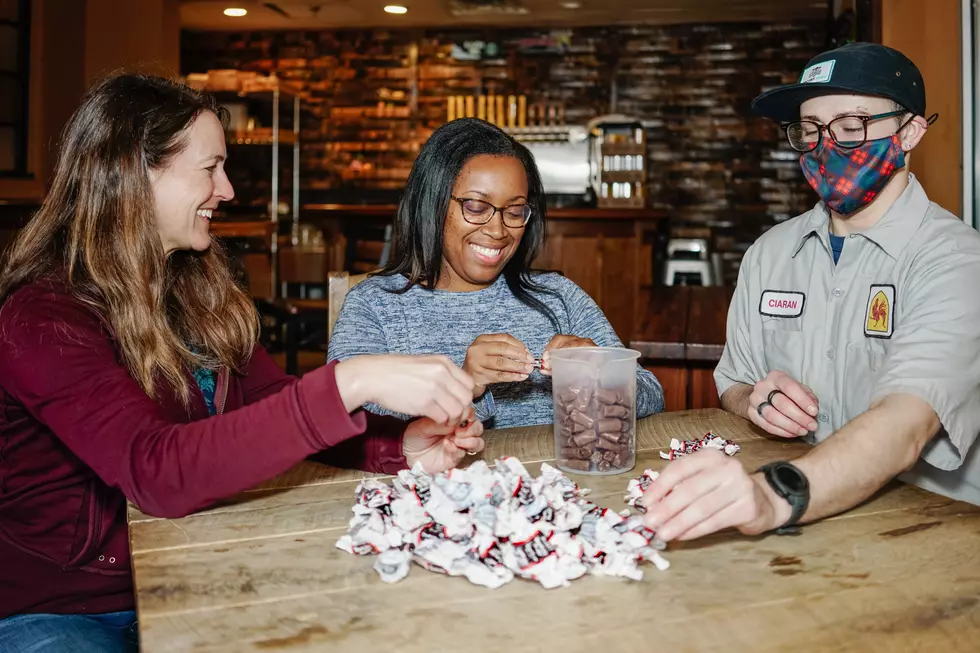 WRC Director of Development & Communications, Tatum Hawkins (pictured, middle) came by the pub to help finish unwrapping tootsie rolls for the beer. Vivant co-owner Kris Spaulding (pictured, left) is co-chair of WRC capital campaign PROPEL. (Brewery Vivant, Facebook)