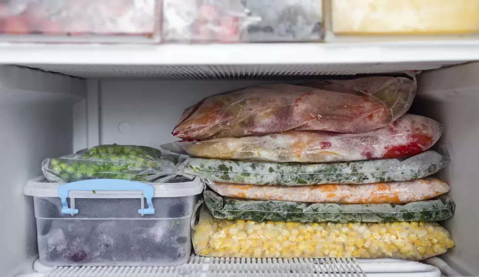 Frozen berries and vegetables in bags in freezer close up