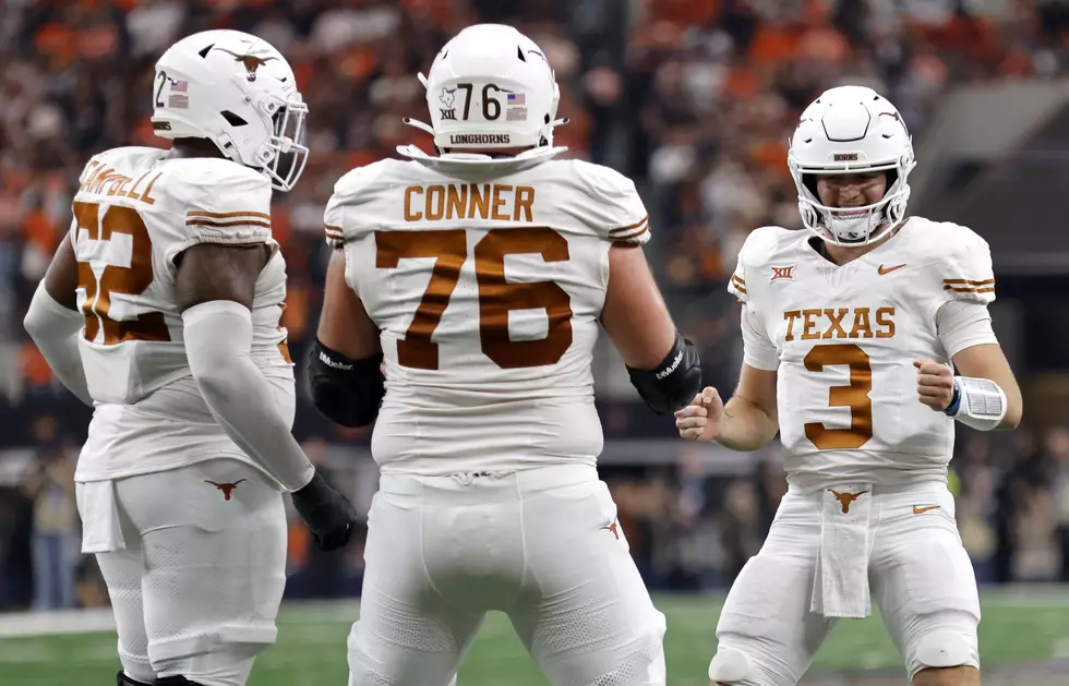 ARLINGTON, TX - DECEMBER 2: Quarterback Quinn Ewers #3 of the Texas Longhorns celebrates with teammates after a touchdown against the Oklahoma State Cowboys in the first half of the Big 12 Championship at AT&T Stadium on December 2, 2023 in Arlington, Texas. (Photo by Ron Jenkins/Getty Images)