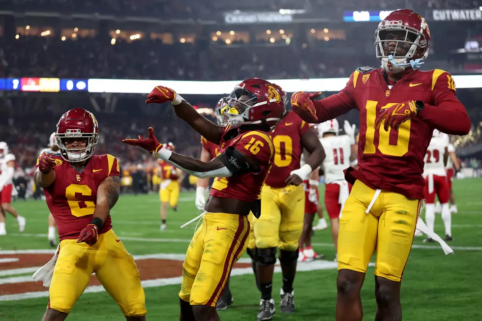 SAN DIEGO, CALIFORNIA - DECEMBER 27: Kyron Hudson #10 and Austin Jones #6 celebrate with Tahj Washington #16 of the USC Trojans after his reception for a touchdown during the first half of the DIRECTV Holiday Bowl against the Louisville Cardinals at Petco Park on December 27, 2023 in San Diego, California. (Photo by Sean M. Haffey/Getty Images)
