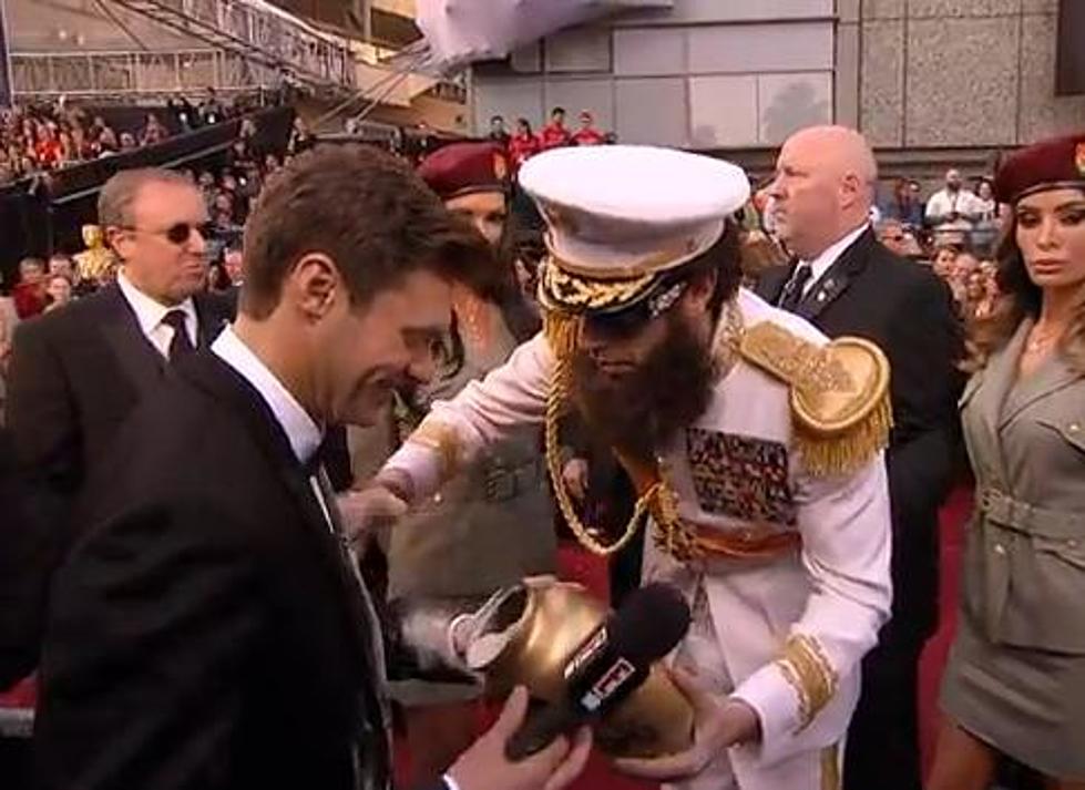 Oscars News: Sacha Baron Cohen Covers Ryan Seacrest In Ashes [Video]