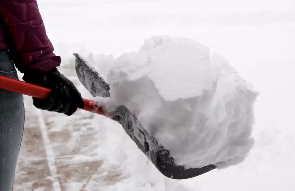 Person shoveling snow in driveway