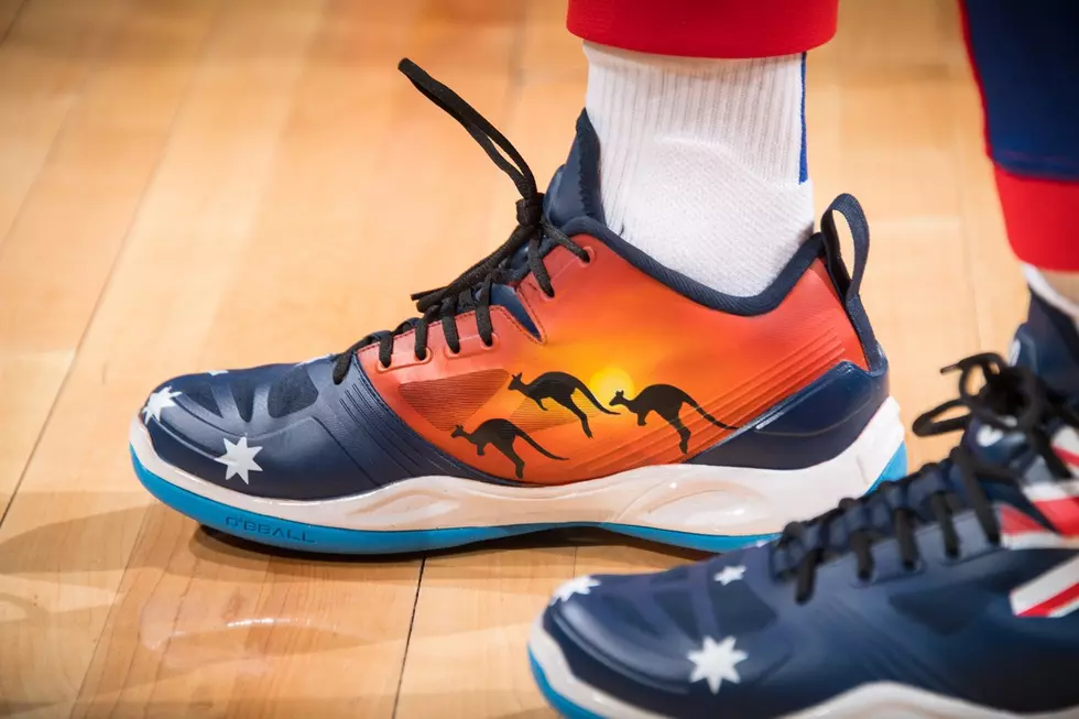 Piston auctioning off shoes for charity.