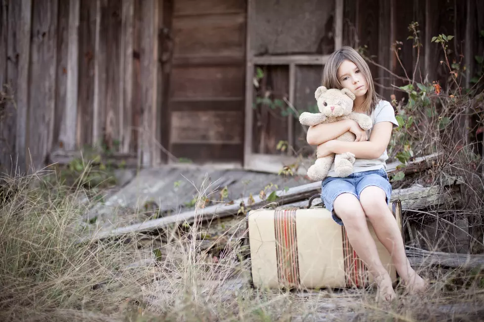 Sad Young Girl Hugging Old, Raggedy Teddy Bear