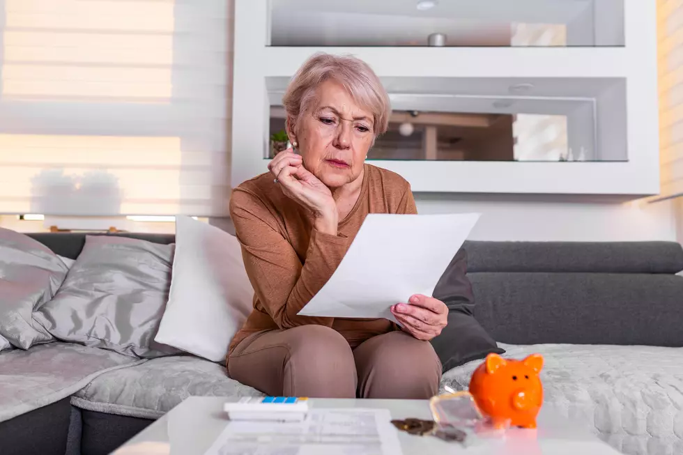 Senior woman doing finances at home. Senior woman with calculator and counting euro money at home. Business, savings, annuity insurance, age and people concept