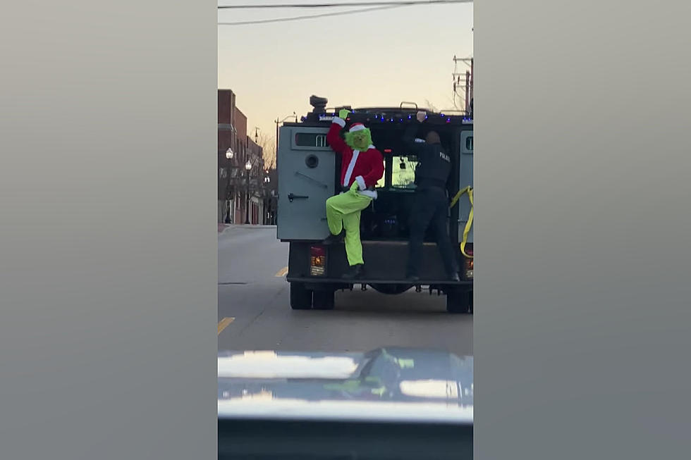 Illinois Grinch Caught Posing on the Back of Moving Police Van