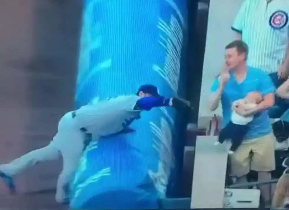 Watch Fan Catch Ball While Holding Baby