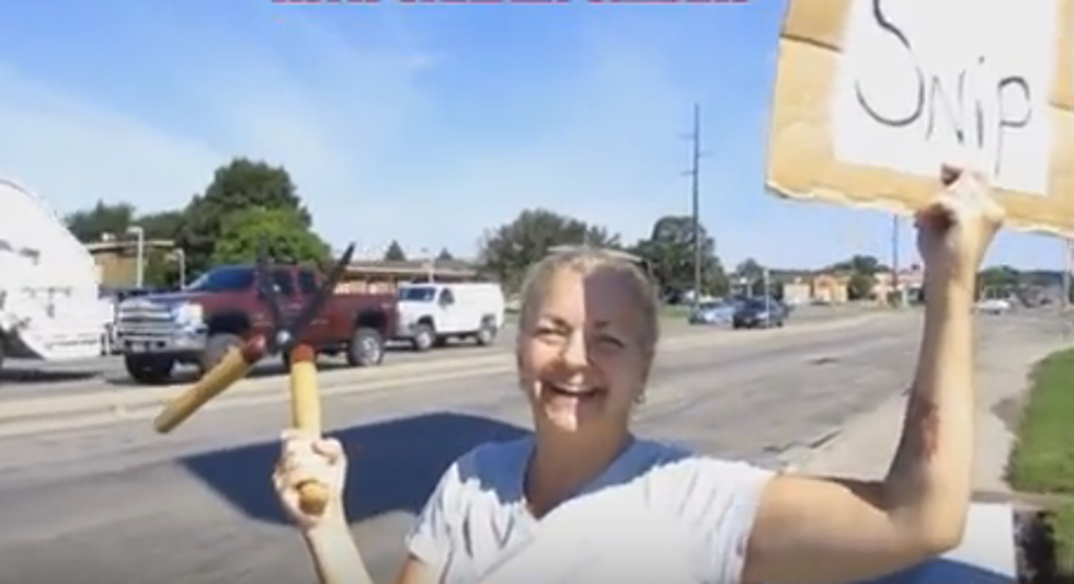 Woman Confronts Circumcision Protesters with Garden Shears