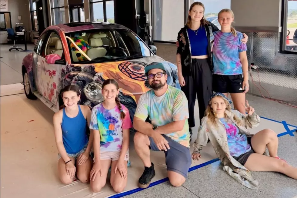 O'Gorman students and teacher with painted VW Bug
