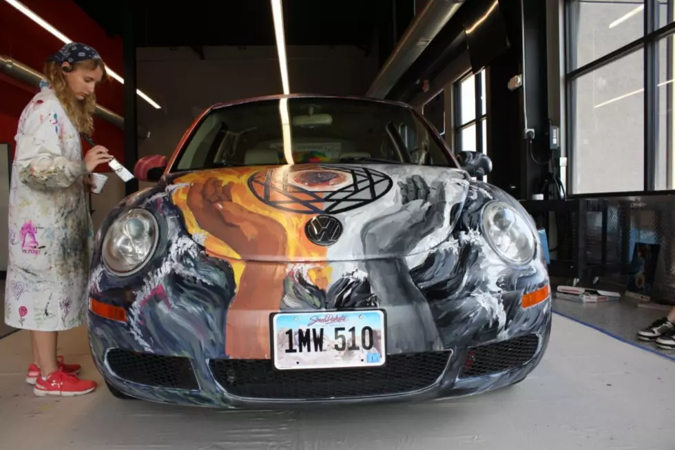 VW Bug being painted by an O'Gorman student