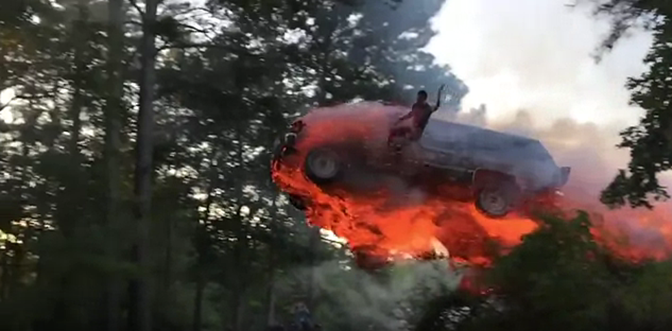 Watch a Dude Start His SUV on Fire and Jump it Into a Lake – On Purpose