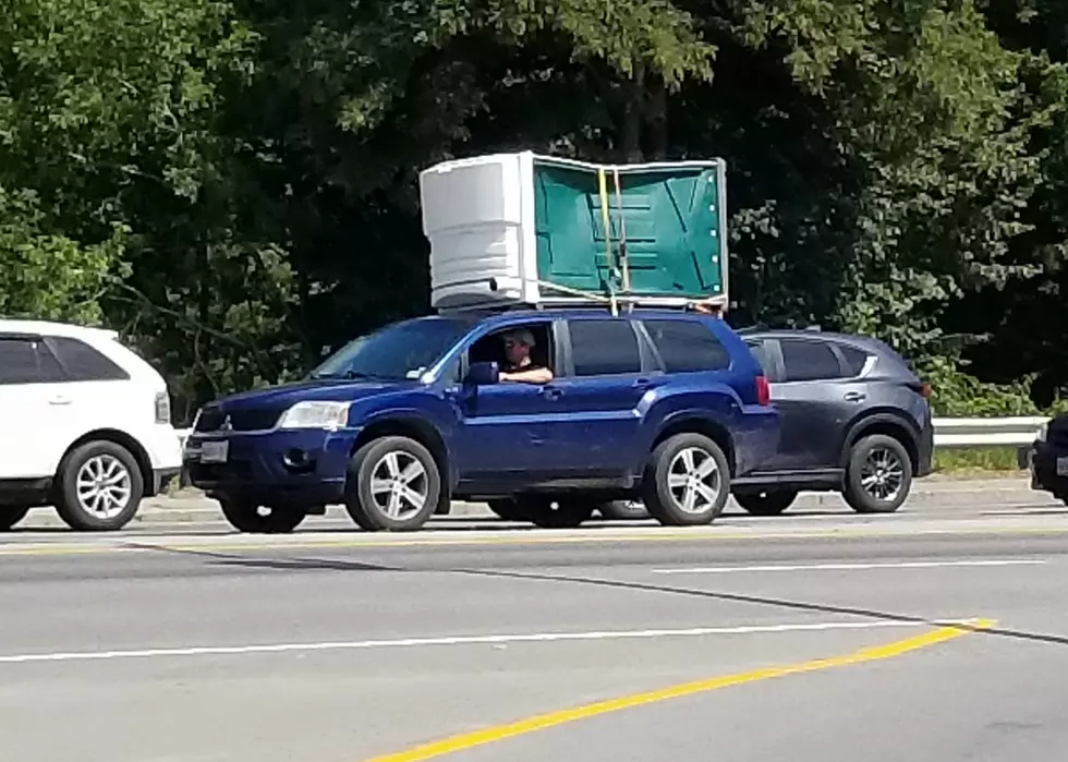 SUV With Porta-Potty on The Roof Seen Driving in Central Maine