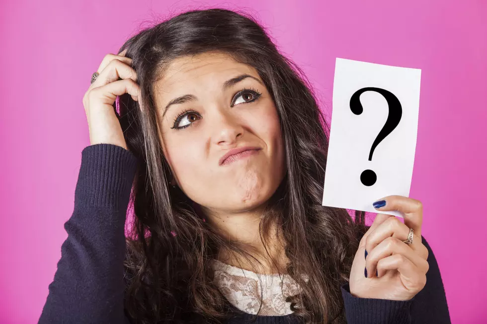 Doubtful Woman holding Question Mark