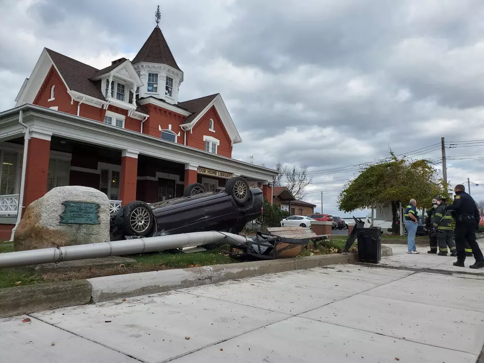Car Knocks Down Pole, Overturns on Lawn of JC Public Library