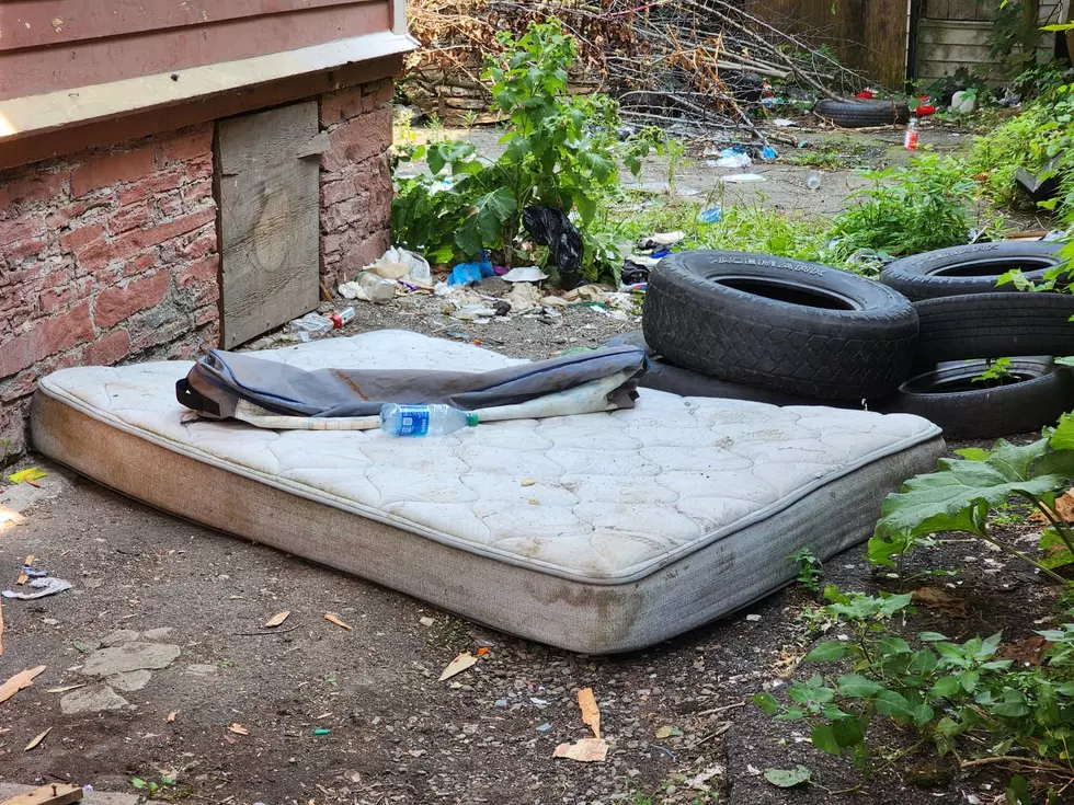 A mattress and tires were among the trash strewn around the abandoned house at 216 Court Street on August 4, 2025. (Photo: Bob Joseph/WNBF News)
