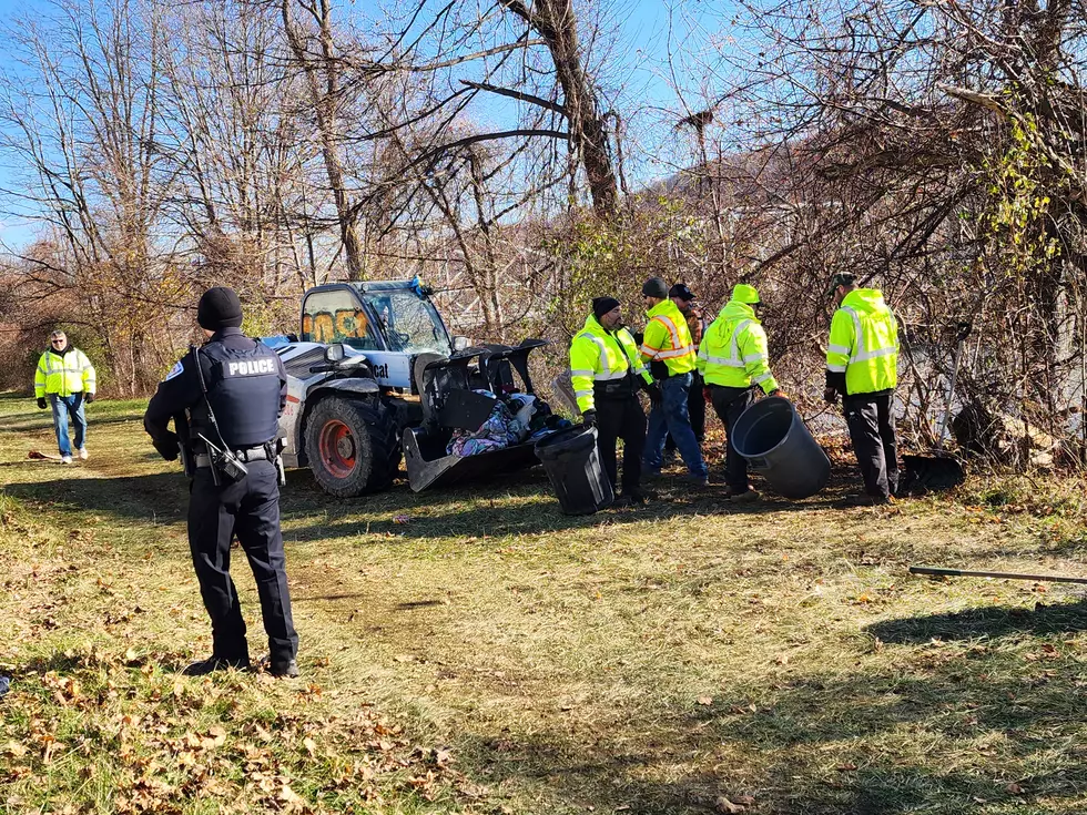 City public works employees and a police officer at the site of a downtown Binghamton homeless encampment. (Photo: Bob Joseph/WNBF News)
