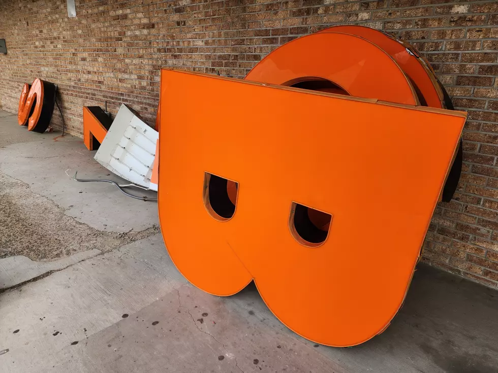The bright orange letters that spelled out BIG LOTS at the closed Vestal store are being tossed out. (Photo: Bob Joseph/WNBF News)