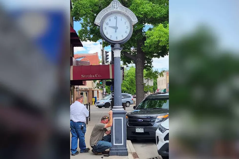 Workers working on Old clock in Downtown Loveland