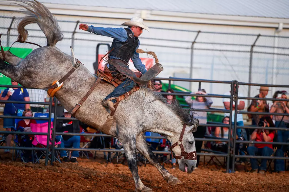A cowboy competes in the saddle bronc event during the 3 Bar