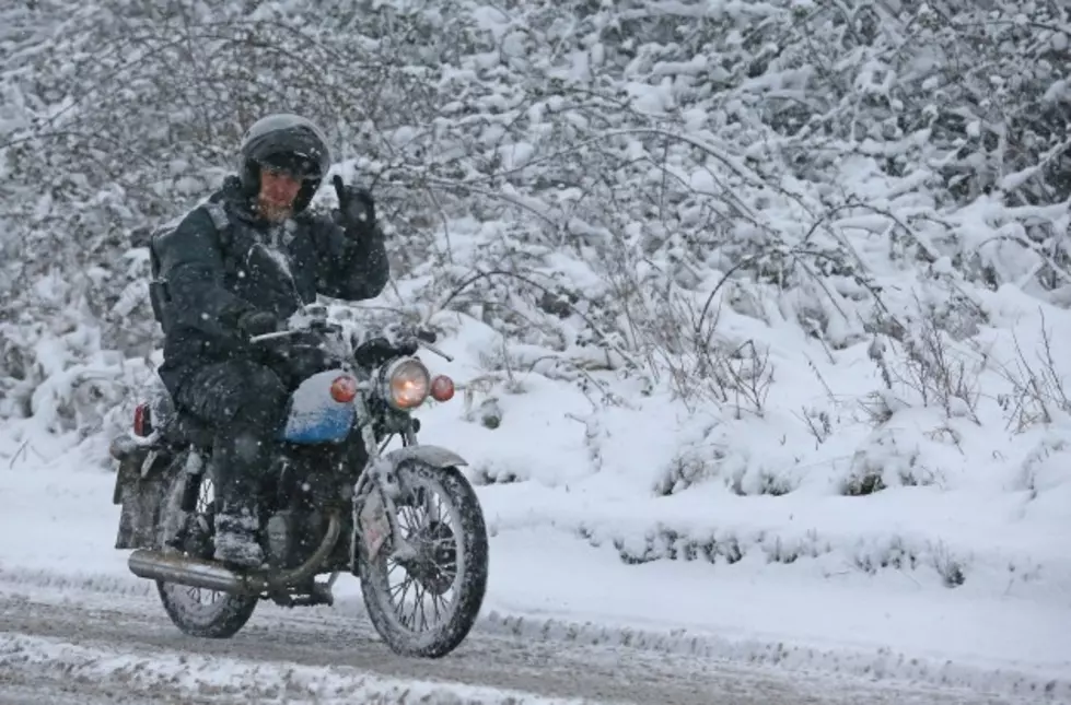 Crazy Dirt Bike Rider Takes a Spin Along Snowy Ridge Top