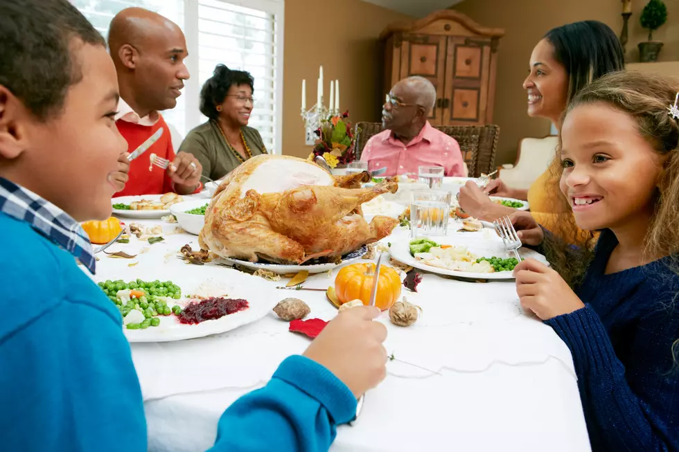 Multi Generation Family Celebrating Thanksgiving Eating At Table Chatting